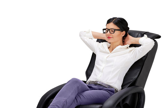 Young woman sitting on relaxing massage armchair