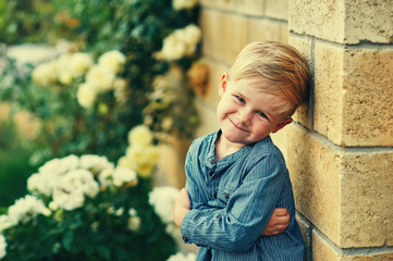 Portrait of a funny little boy outdoors
