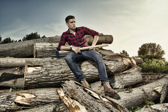 Lumberjack worker sitting in the forest
