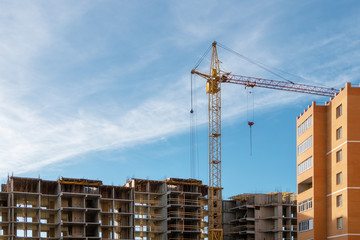 A crane near the multi-storey building under construction