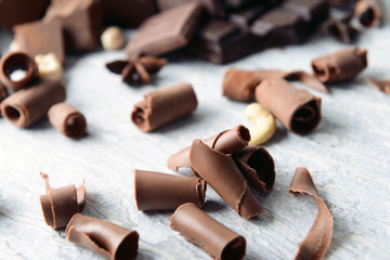 Delicious chocolate curls on table