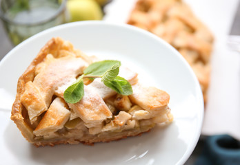 Woman holding plate with piece of tasty apple pie