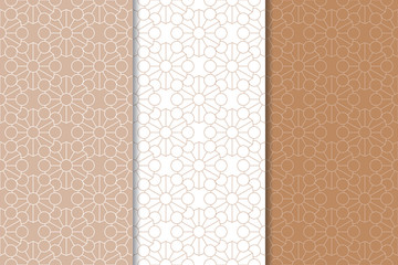 Set of geometric ornaments. Brown and white seamless patterns