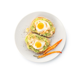 Delicious toasts with avocado and eggs on plate, isolated on white