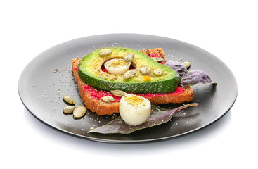 Delicious toast with avocado on plate, isolated on white