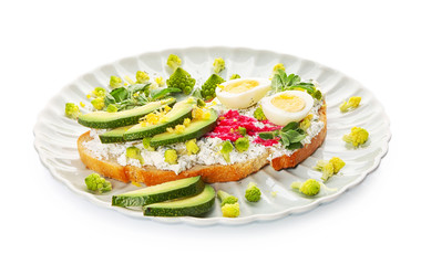 Delicious toast with avocado and egg on plate, isolated on white