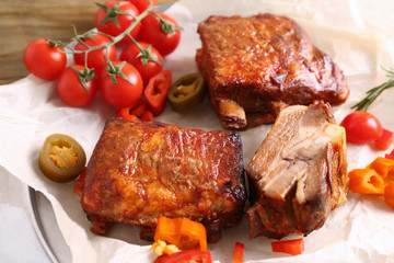 Delicious grilled ribs with vegetables on parchment
