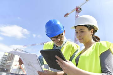 Construction manager and engineer working on building site