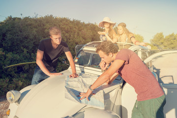 Group on vacations looking at a map