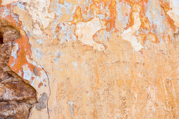 Old Cracked Weathered Shabby Yellow Painted Plastered Peeled Wall Background.