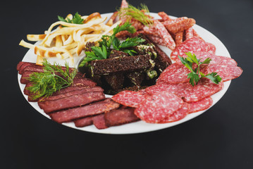 A set of different sausage meat on black background