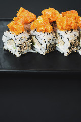 Set of different sushi rolls on black background