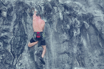 Man climber climb a cliff without safety rope