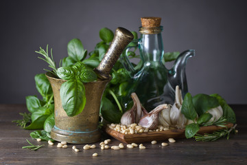 Ingredients for making pesto on a old wooden table .