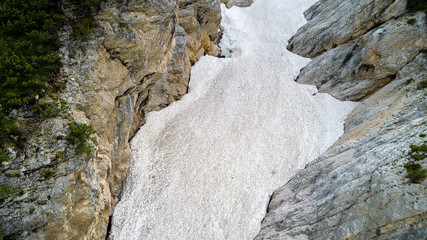 Aerial view of the mudflow with snow high in the Alpine mountains