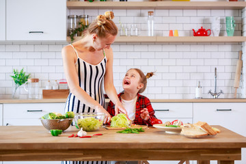 Image of woman with daughter cooking food in kitchen