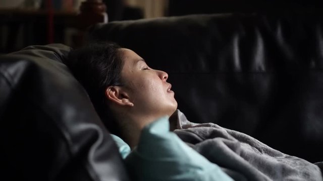 Asian woman sick alone sleeping at sofa with blanket video