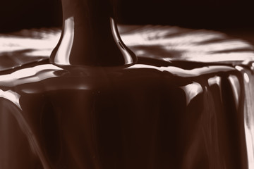 Pouring liquid hot chocolate closeup. Cooking dessert.