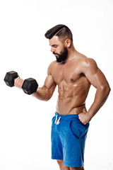 Fototapeta na wymiar muscular man doing exercises with dumbbells.