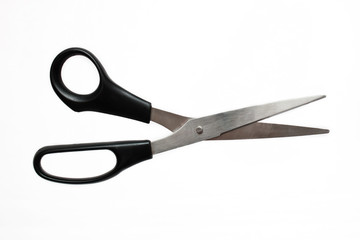 Metal scissors with black pen on white background