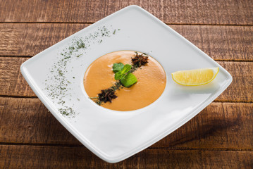Lentils cream soup on wooden background