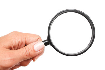 Female hand with a magnifying glass on a white background