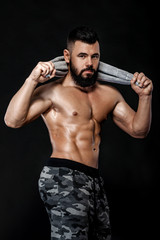 Fototapeta na wymiar bodybuilder with towel on black background