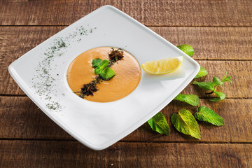 Lentils cream soup on wooden background