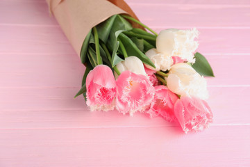 Obraz na płótnie Canvas Bouquet of beautiful tulips on wooden background