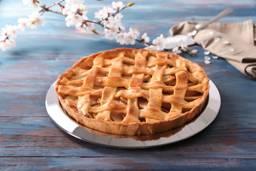 Plate with tasty homemade apple pie on wooden table