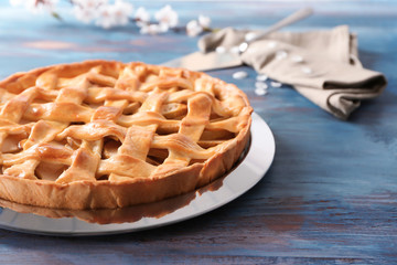 Plate with tasty homemade apple pie on wooden table