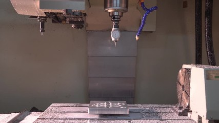 Metalworking at the factory. The computer-controlled machine cuts the part out of aluminum. Machine with program control 4k