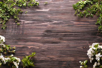Beautiful blossoming branches on wooden background