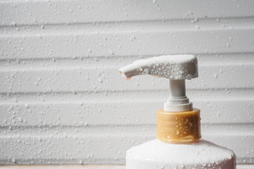 Fototapeta na wymiar Water drop on liquid soap dispenser pump during bath time