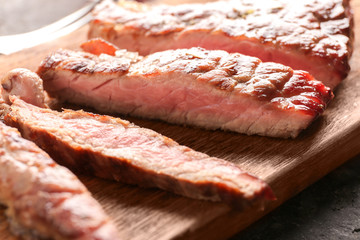 Tasty grilled steak on wooden board, closeup