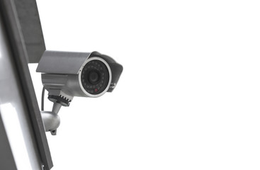 Modern CCTV camera installed on wall of building outdoors