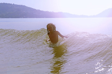 A teenager in a sea wave. Child at sea in the water
