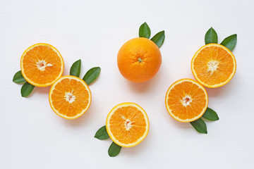 Fresh orange citrus fruit with leaves on white backgrou