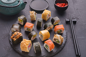 Set of sushi maki and rolls on gray background