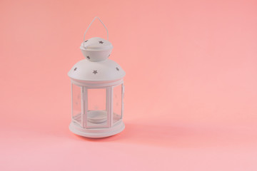 A white Ramadan lantern on pink background