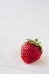 Strawberries ripe on a white wooden background. Copy space. Healthy lifestyle concept