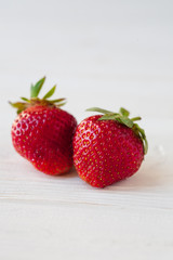 Strawberries ripe on a white wooden background. Copy space. Healthy lifestyle concept