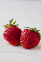 Strawberries ripe on a white wooden background. Copy space. Healthy lifestyle concept