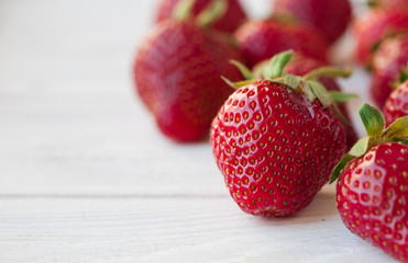 Strawberries ripe on a white wooden background. Copy space. Healthy lifestyle concept