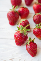 Strawberries ripe on a white wooden background. Copy space. Healthy lifestyle concept