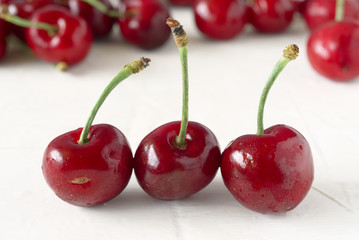 ripe cherries on white textured background