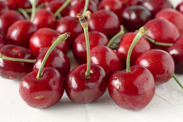 ripe cherries on white textured background
