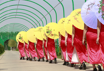 Women in cheongsam are walking