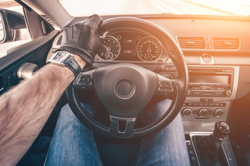 View from the driver's face in the first person's eyes from the driver's seat of the car, a gloved...