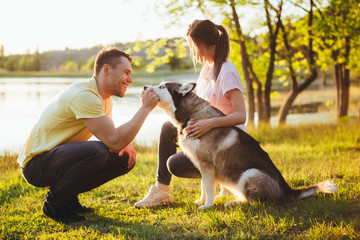 Lifestyle, happy family of two resting at a picnic in the park with a dog. © galina_kovalenko